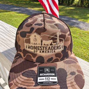 Camouflage Homesteaders Trucker Cap on Porch (1)